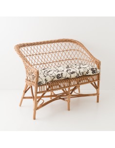 Canapé en osier Antonin avec coussin fond gris feuillage blanc