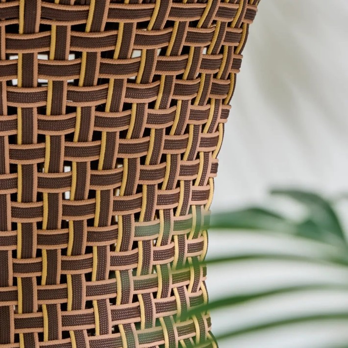 Detail of curved leg of TALI round outdoor dining table