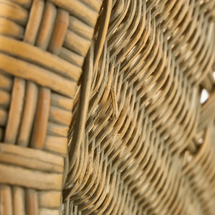 Detail of a flaw in the rattan of a Marcel armchair with a patina finish