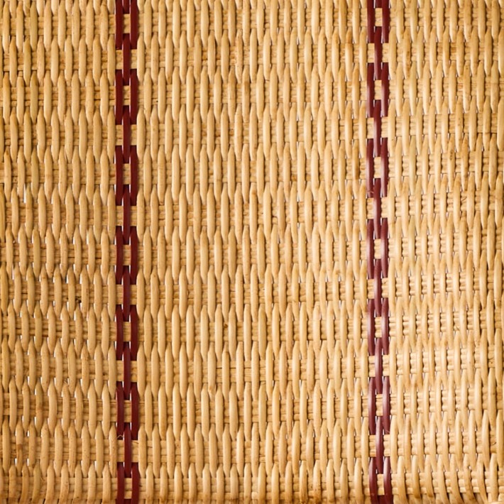 Red border detail typical of the Bagatelle woven rattan collection