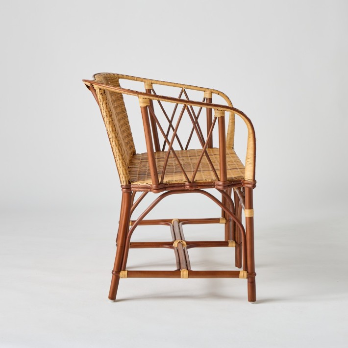 Side view of Bagatelle rattan bench Brown rattan frame with light rattan weave and red edging