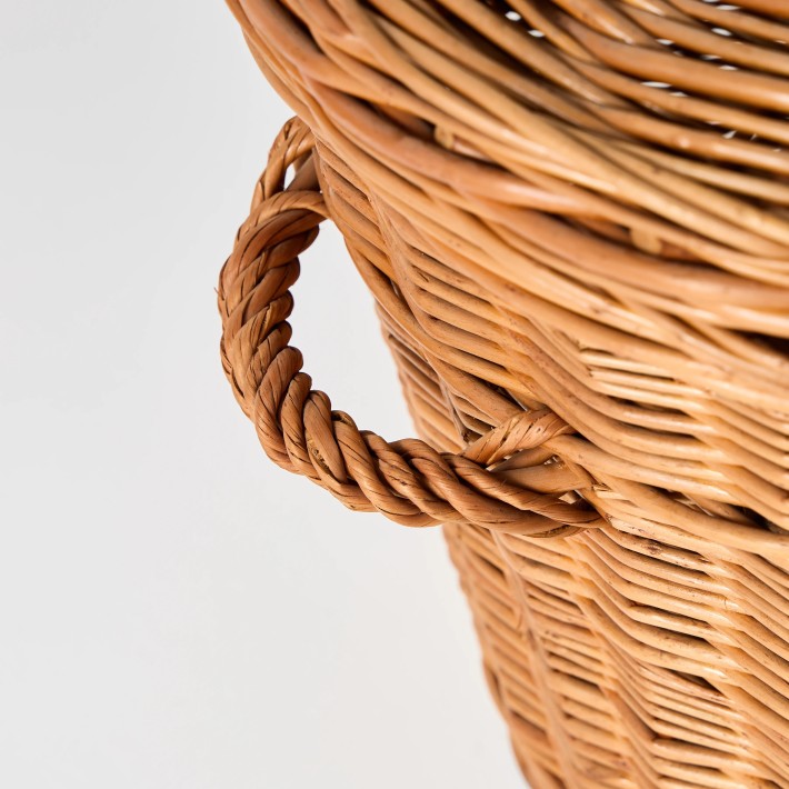 Detail of woven wicker handle on vintage storage basket with lid, one-of-a-kind piece