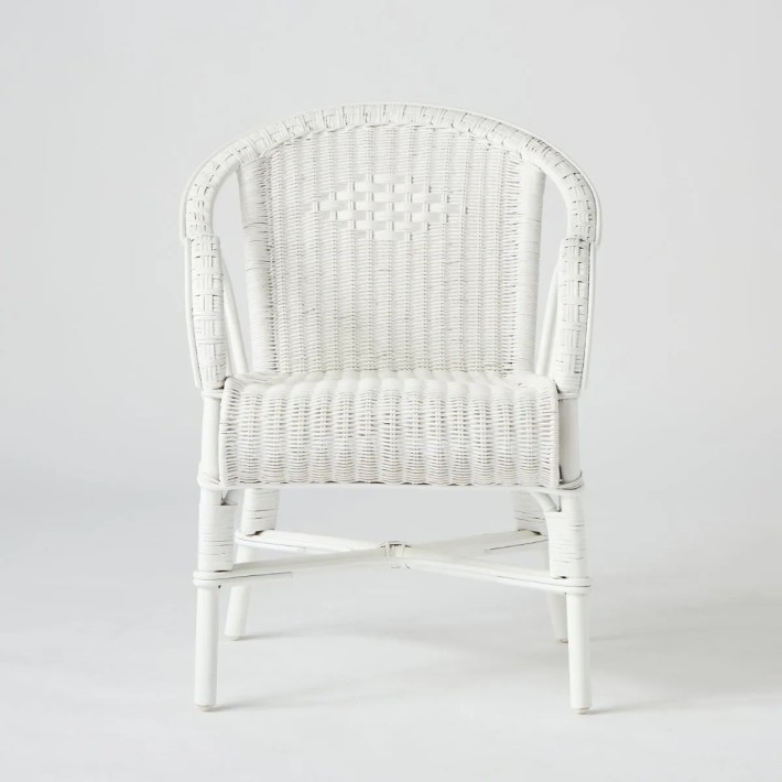 Front view of Primavera table chair in white lacquered woven rattan
