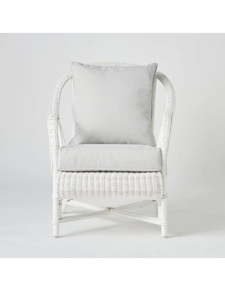 Front view of white lacquered woven rattan armchair with PRIMAVERA cushions