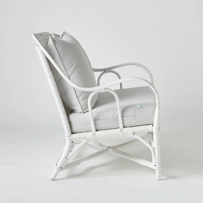 White lacquered woven rattan two-seater sofa with grey cushions from the PRIMAVERA collection at KOK maison