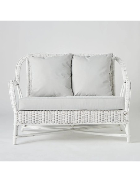Front view of white lacquered rattan two-seater sofa from the Primavera collection by Kok Maison
