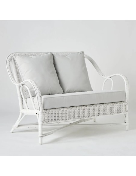 White lacquered woven rattan two-seater sofa with cushions from the Primavera collection at Kok Maison