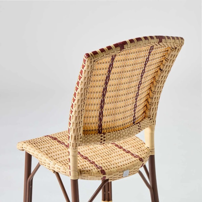 Detail of the back of a hand-woven imitation rattan resin chair for Kok maison