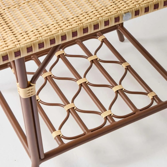 Detail under rectangular coffee table top for terrace in woven rattan-effect resin