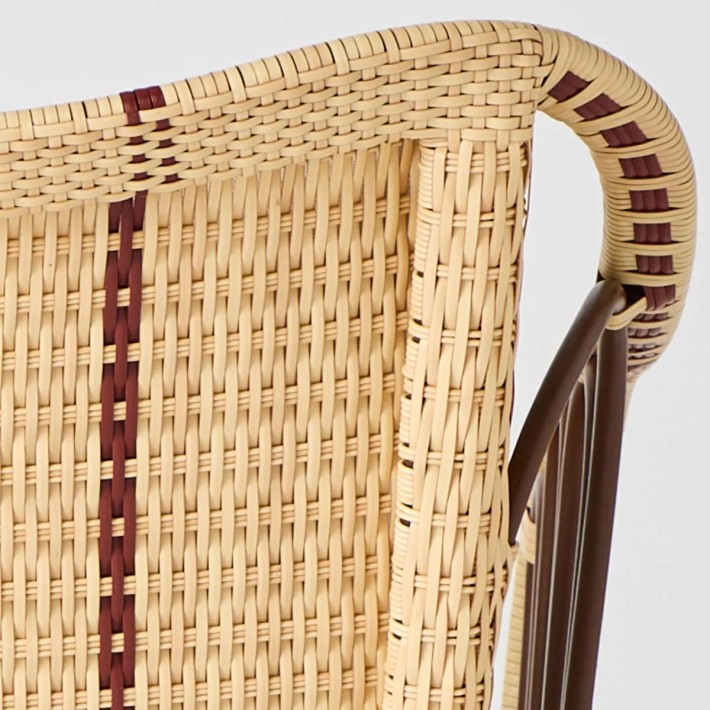 Detail of Belle Époque-style imitation rattan resin weave with red edging by Kok Maison