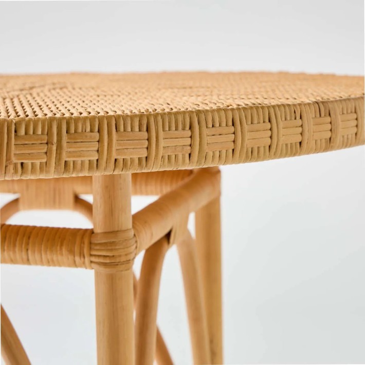 Zoom on the woven detail of the rattan tabletop of the Eugénie table in honey colour, exclusively available online.