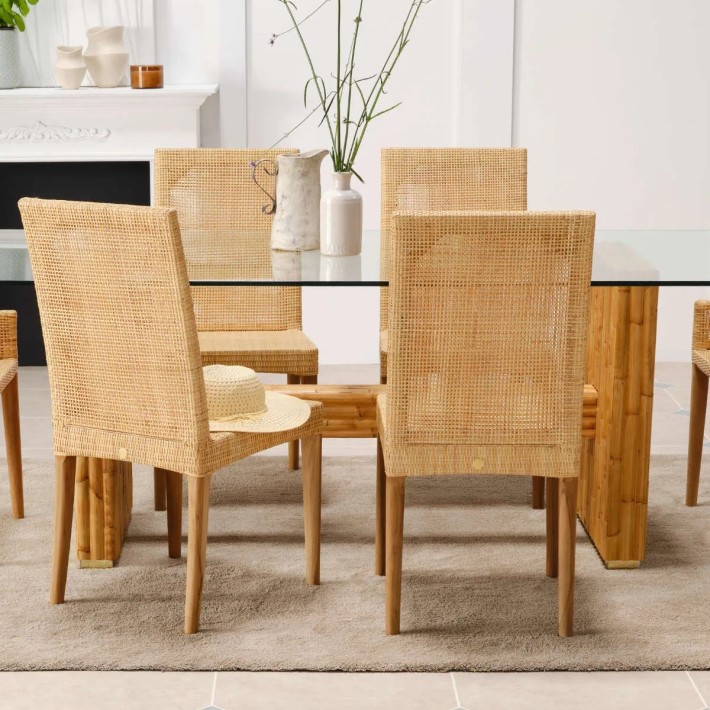 Detail of woven rattan chair backrest with teak legs from the SAIGON collection