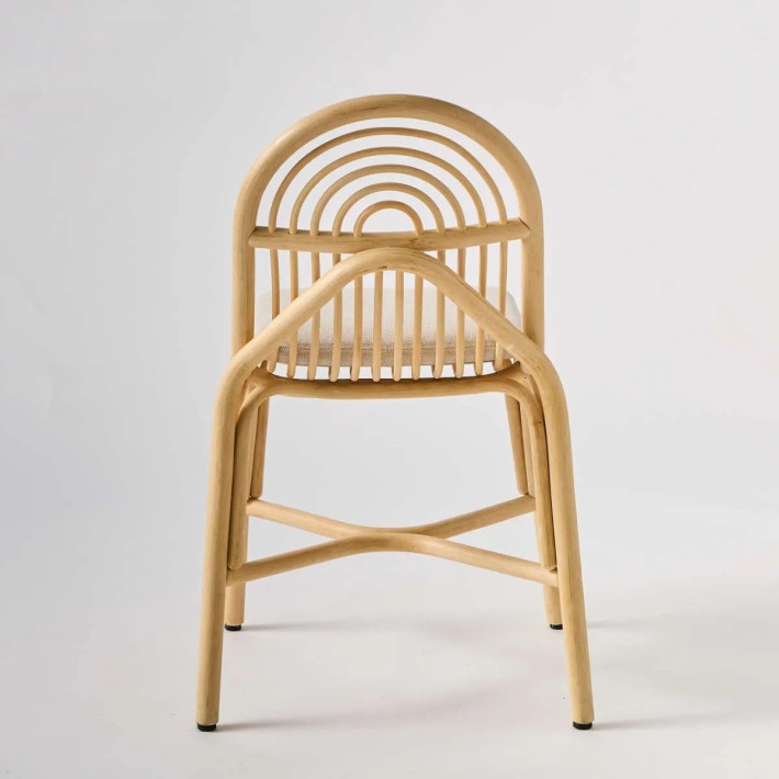 Rear view of Sillon rattan chair with cushion. Contemporary rattan and French design at Kok Maison.