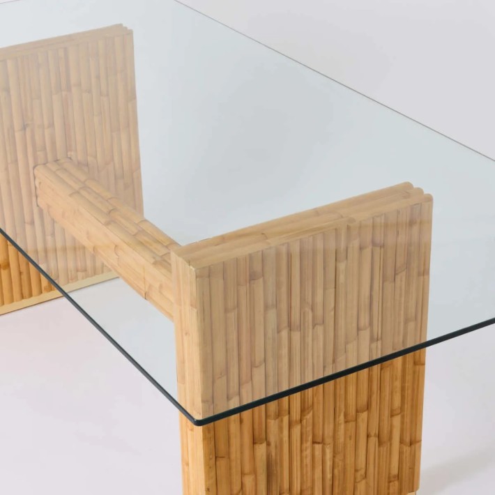 View of the rattan base through the glass top of the Riviera rectangular dining table