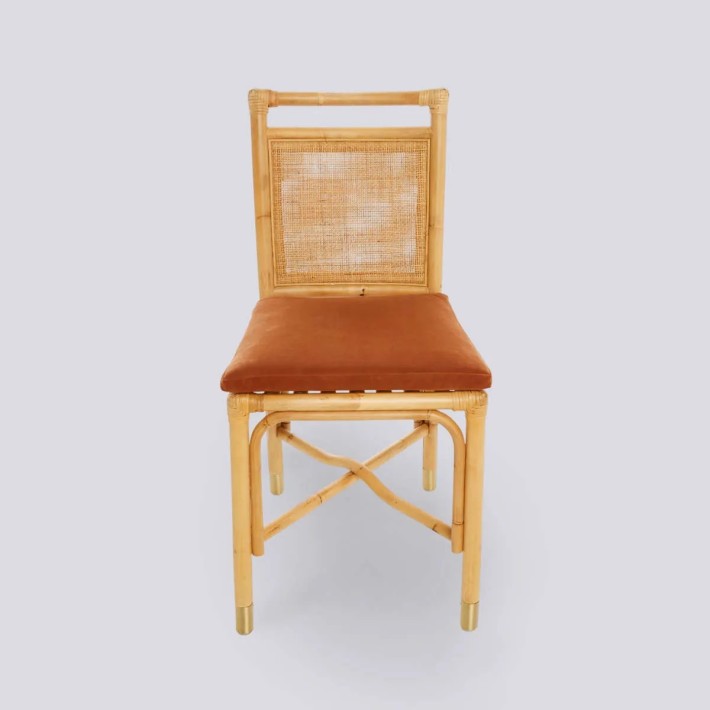 Front view of RIVIERA rattan chair with ochre velvet cushion