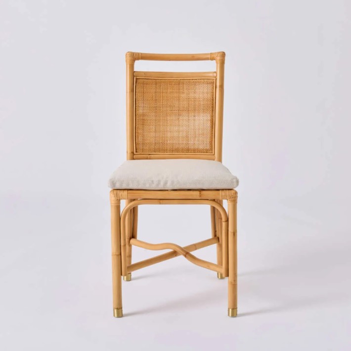 Front view of Riviera rattan chair with beige fabric