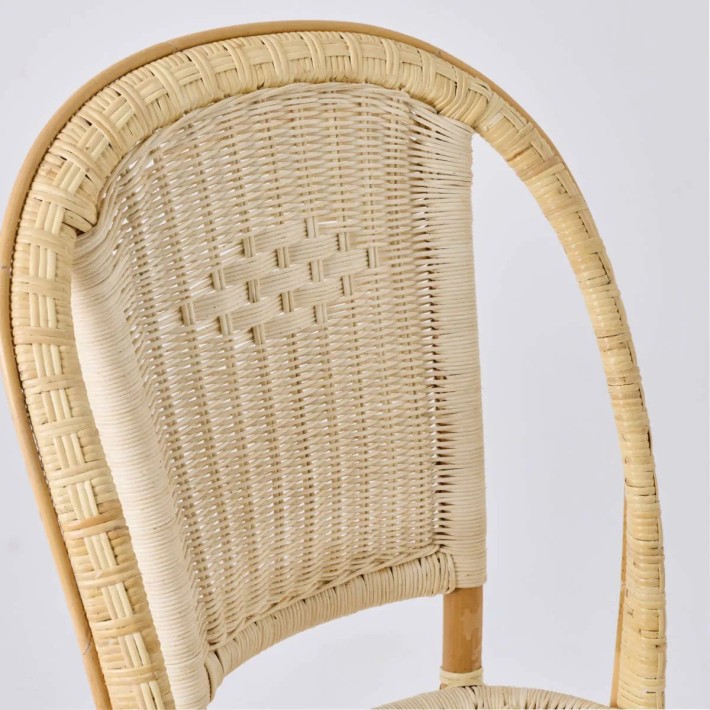 Detail of the woven backrest of the Albertine chair with its iconic diamond pattern