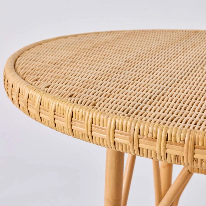 Detail of natural rattan braided edge on EUGENIE table by KOK Maison