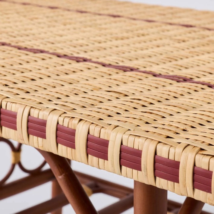 Close-up detail of red resin and natural rattan weave coffee table from the BAGATELLE collection