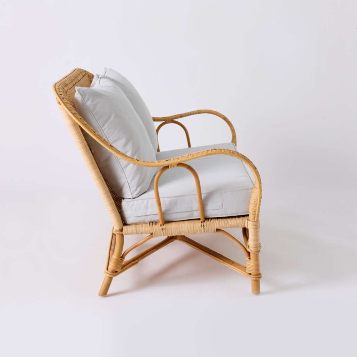 Side view of NANTUCKET natural rattan sofa from the Grandfather collection in pearl grey fabric