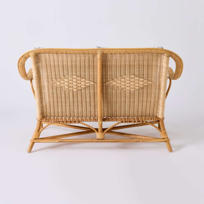 Rear view of NANTUCKET natural rattan sofa from the Grandfather collection in pearl grey fabric