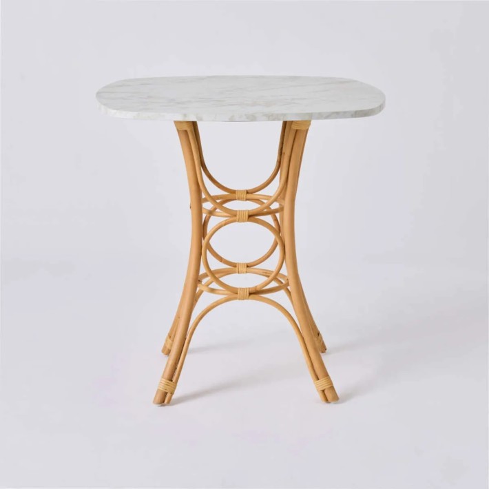 Front view of the base of the GINGKO rattan dining table/stool with a square white marble-effect top