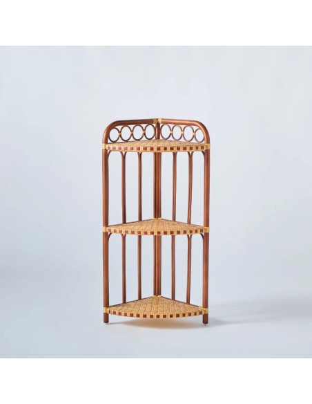Front view of a corner shelf with three rattan shelves. BAGATELLE collection.