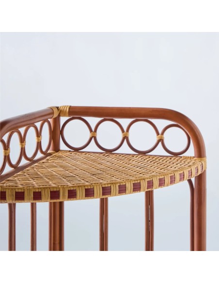Close-up of a woven rattan tray with red resin edging from the BAGATELLE collection