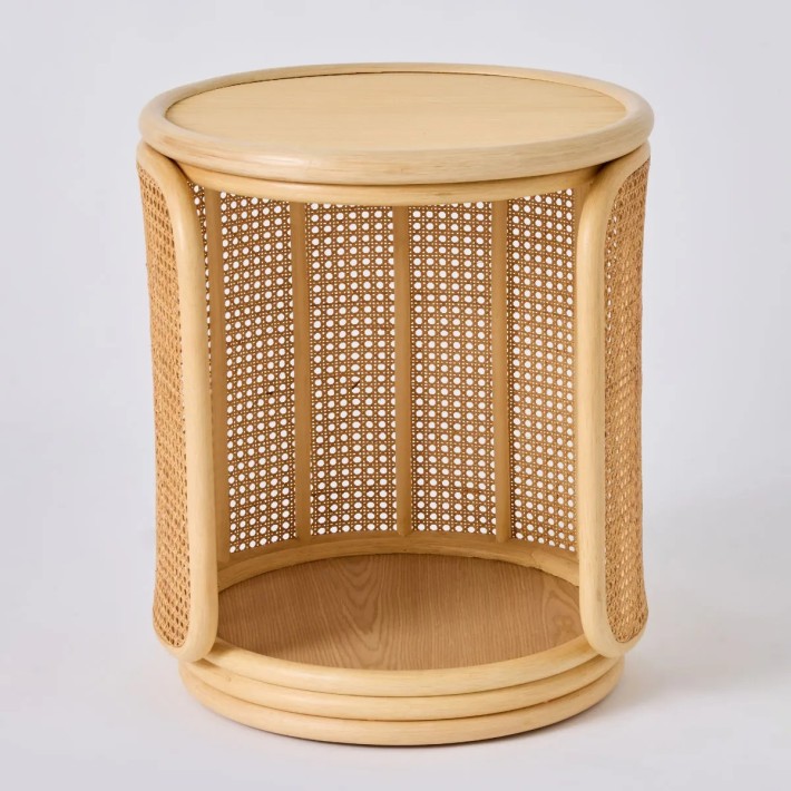 Front view of a rattan tambourine-style bedside table with a rattan top