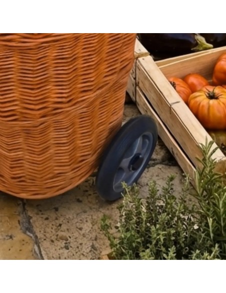 Detail of the large plastic wheels on the brown wicker shopping basket