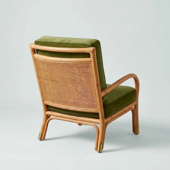 Rear view of the RIVIERA collection armchair with a woven rattan backrest
