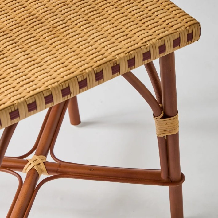 Close-up of the tabletop and legs of the BAGATELLE rattan coffee table
